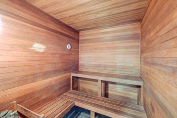 A wooden sauna with a bench and a door